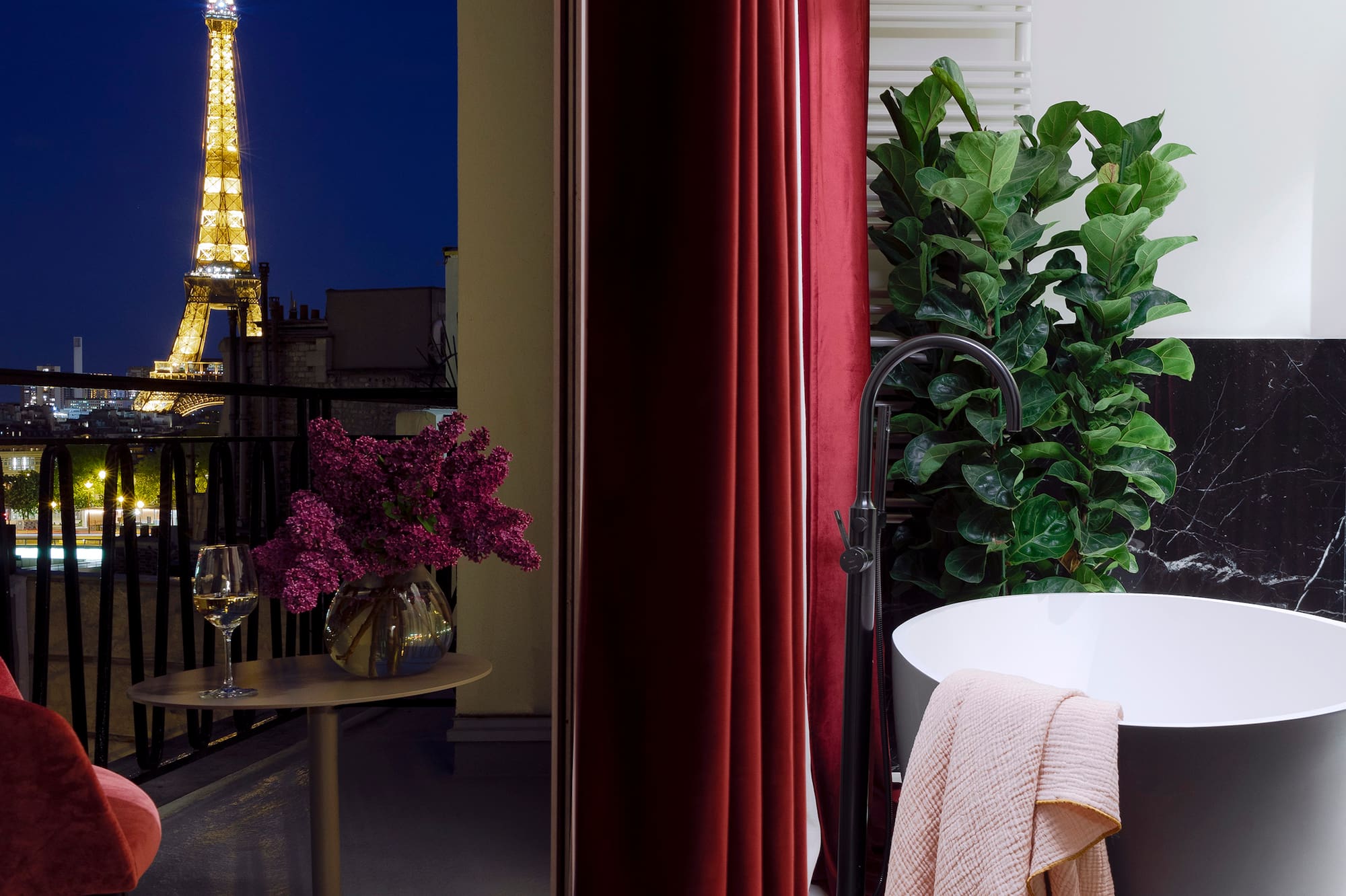 a bathroom with a tub and a red curtain
