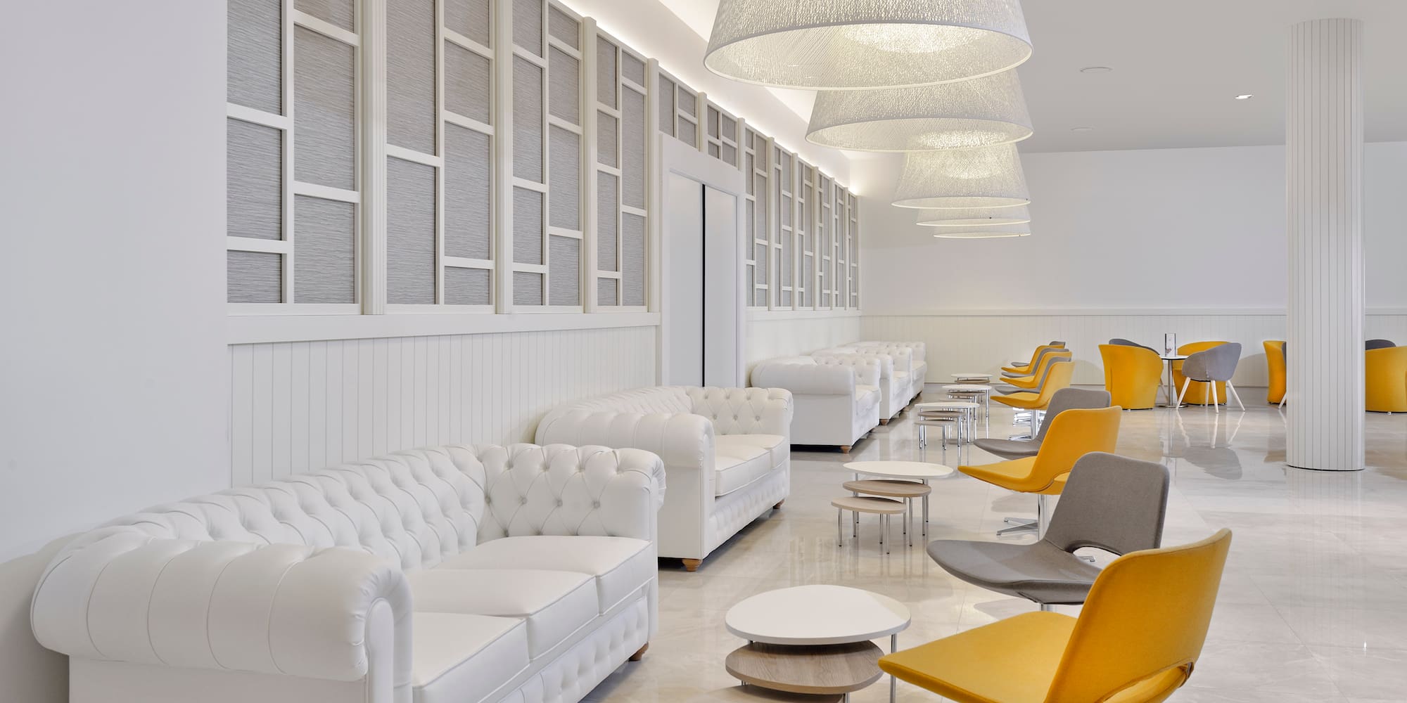 a room with white furniture and chairs