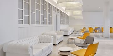 a room with white furniture and chairs