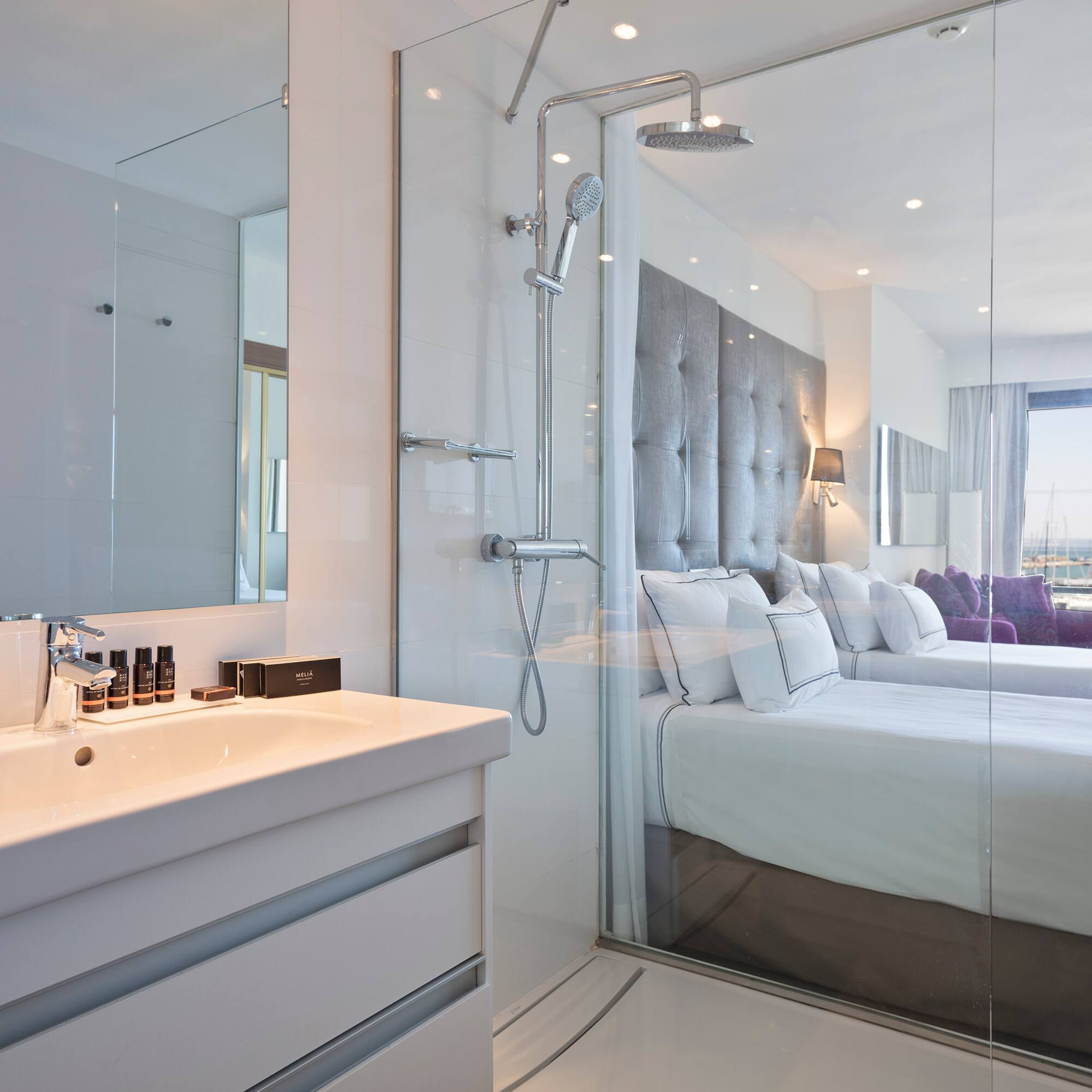 a bathroom with a shower and a bed