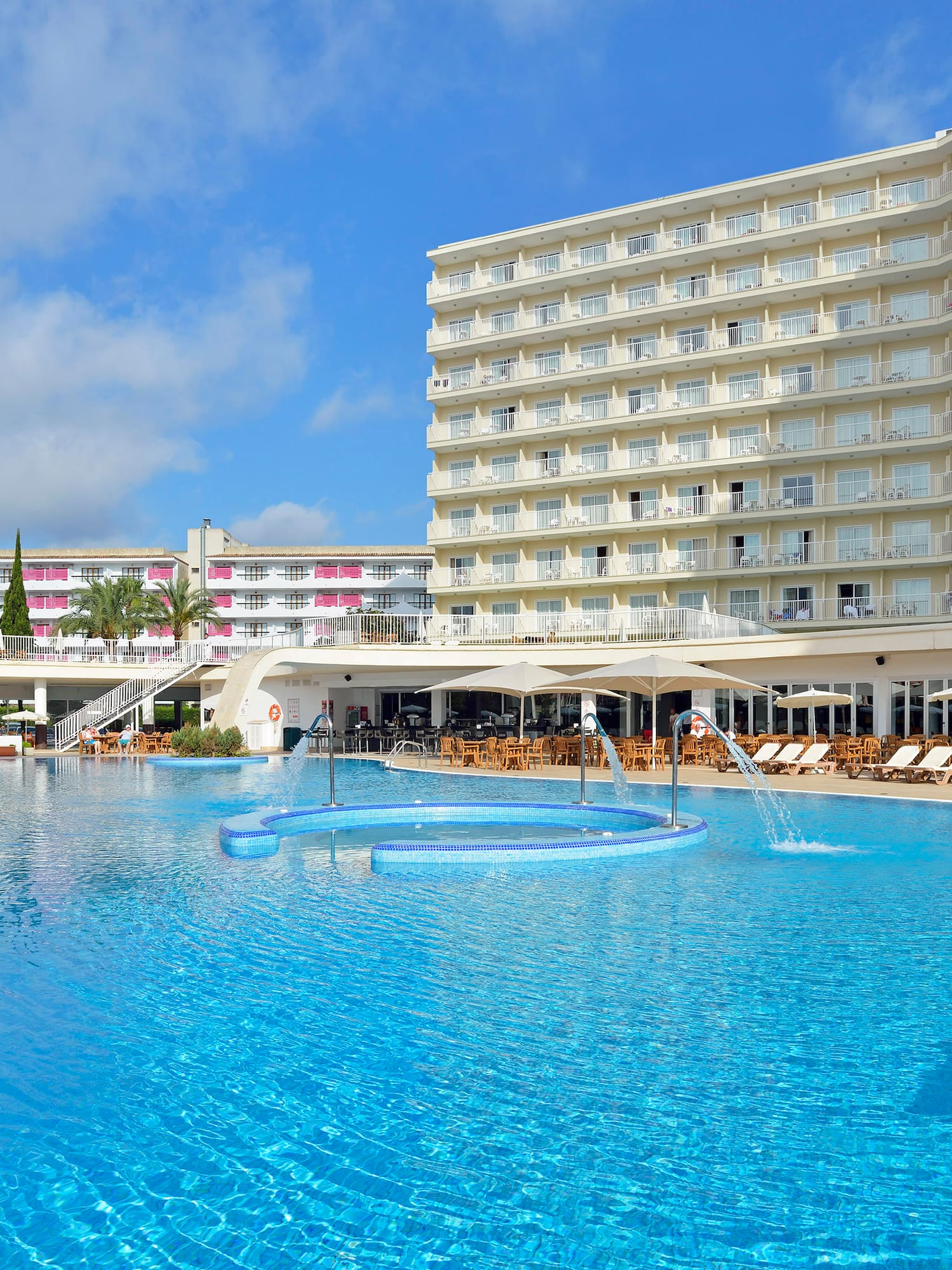 a large pool with a large building in the background
