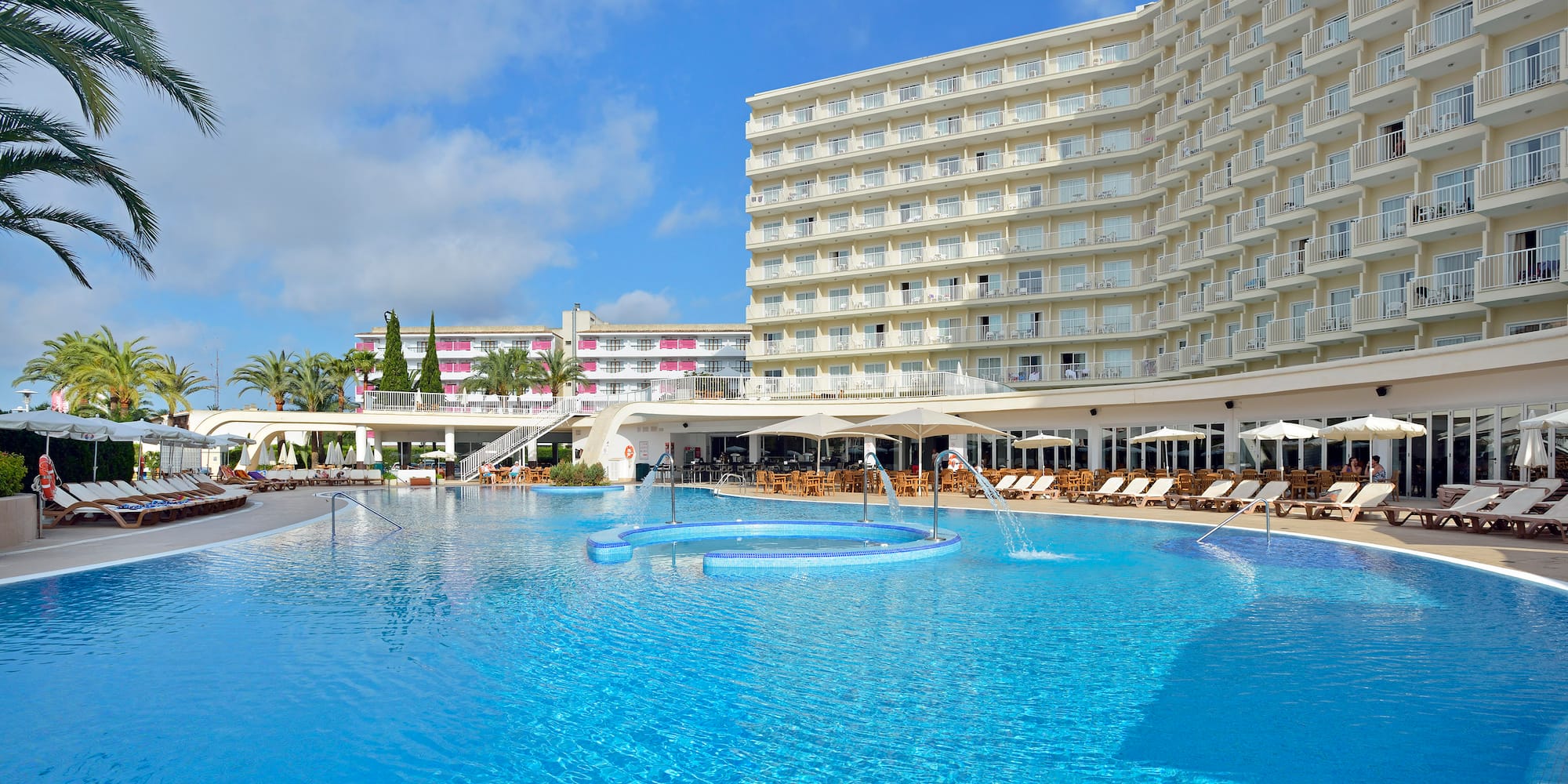 a large pool with a large building in the background
