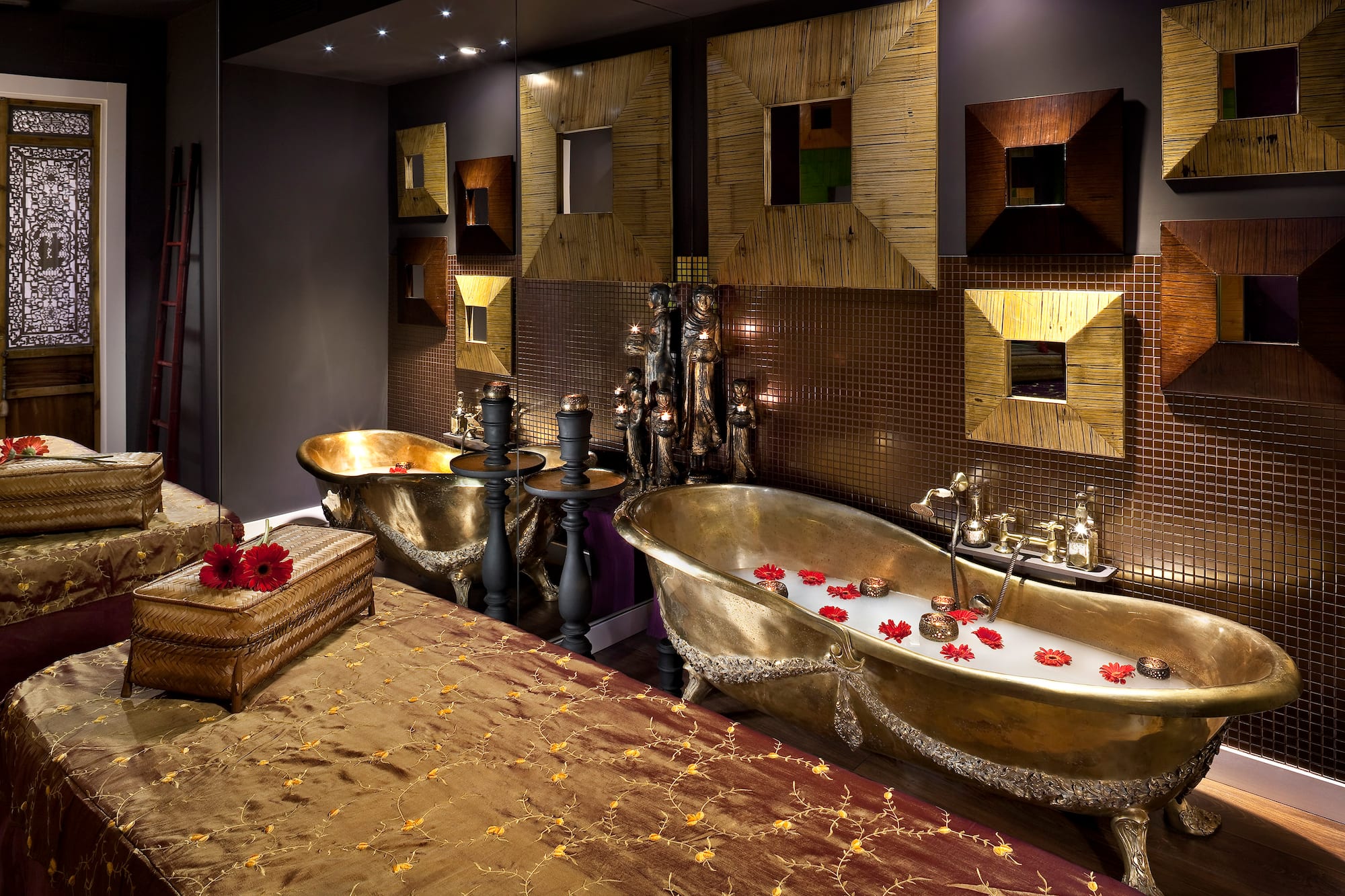 a bathroom with a bed and bathtubs