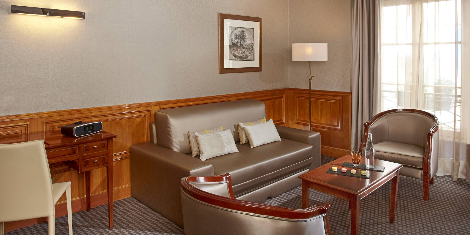 a room with a couch and chairs