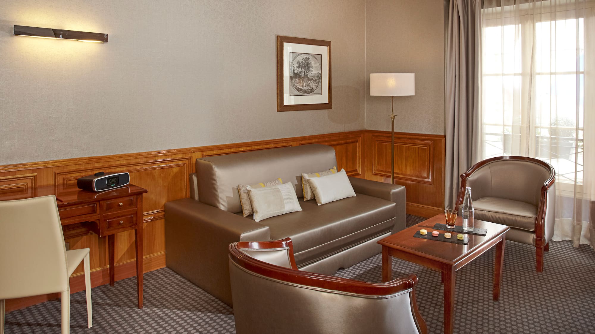 a room with a couch and chairs