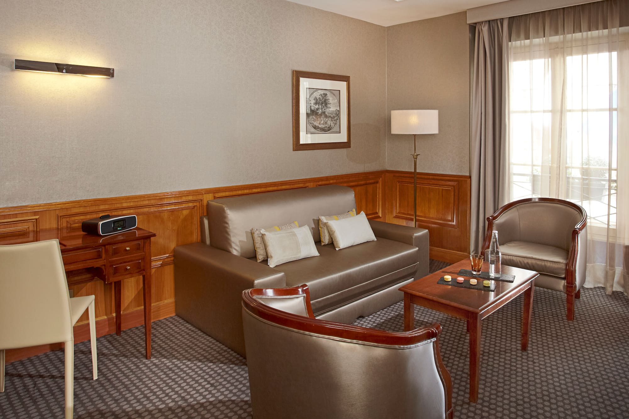 a room with a couch and chairs