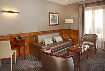 a room with a couch and chairs