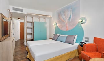 a room with a bed and a picture on the wall