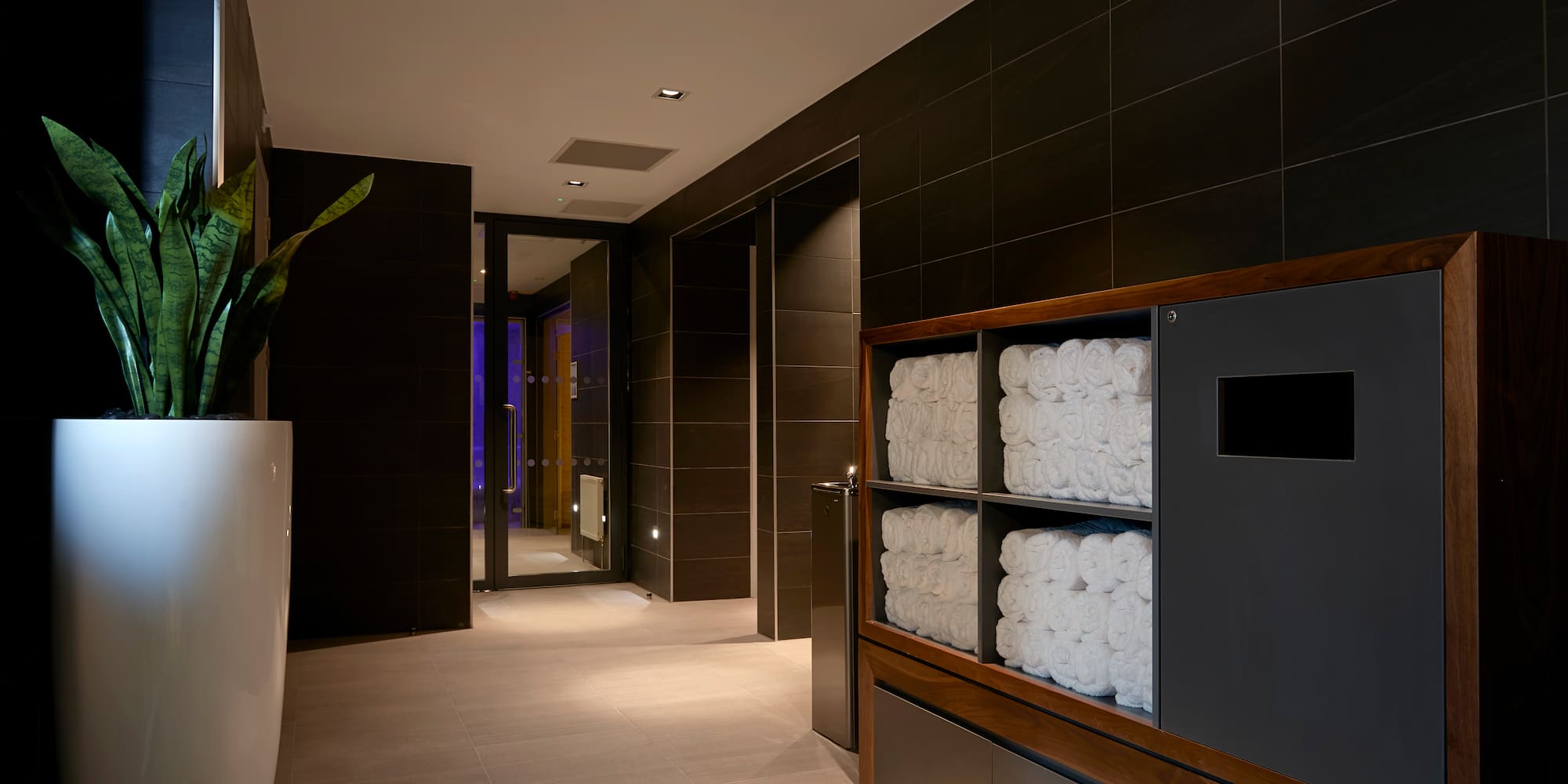 a bathroom with towels stacked on shelves