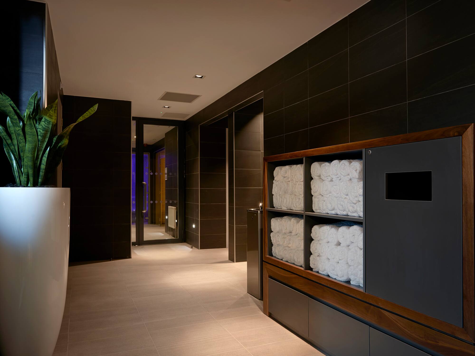 a bathroom with towels stacked on shelves