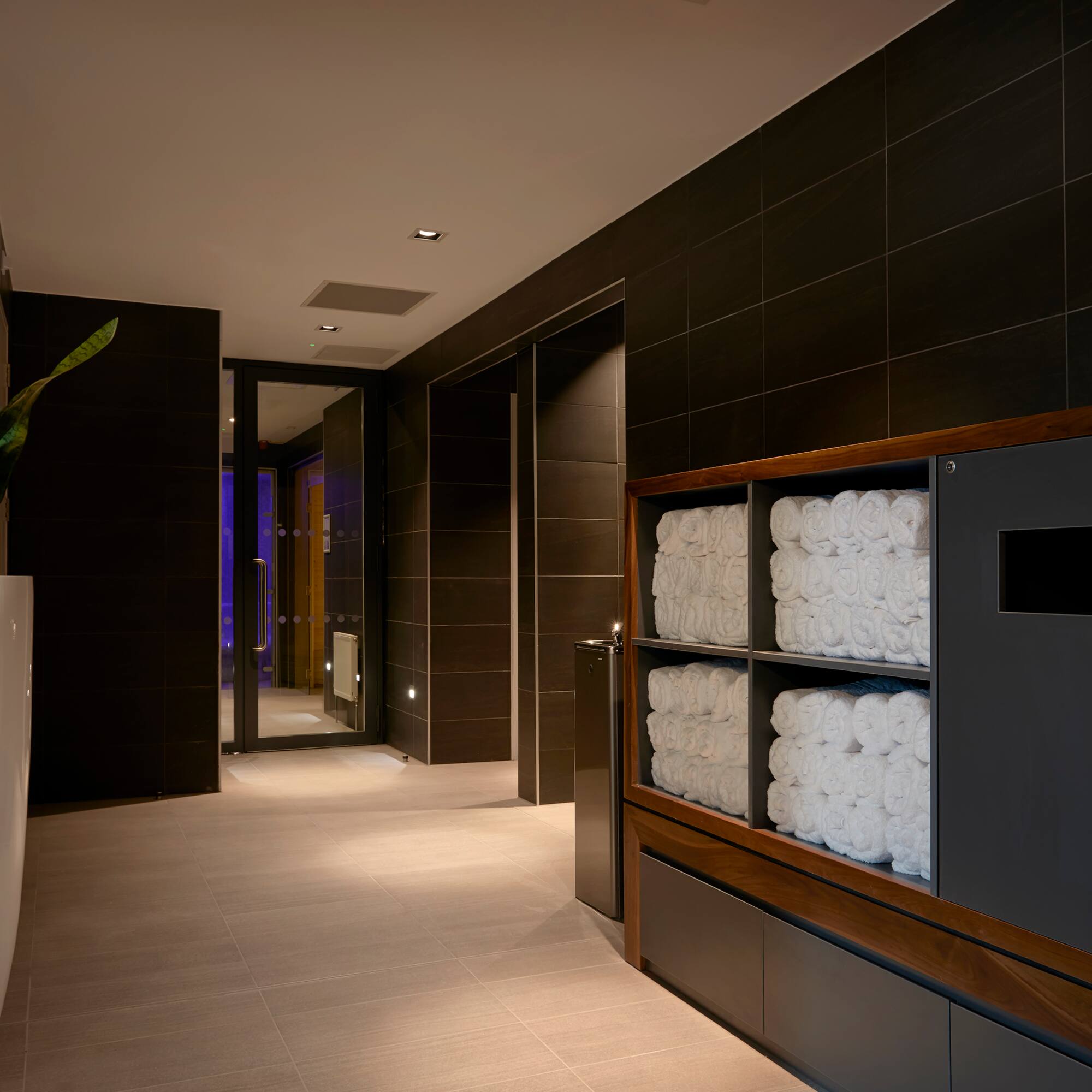a bathroom with towels stacked on shelves