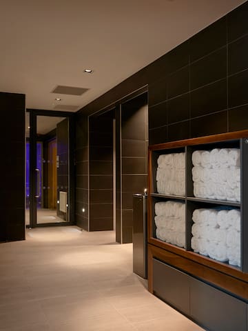 a bathroom with towels stacked on shelves