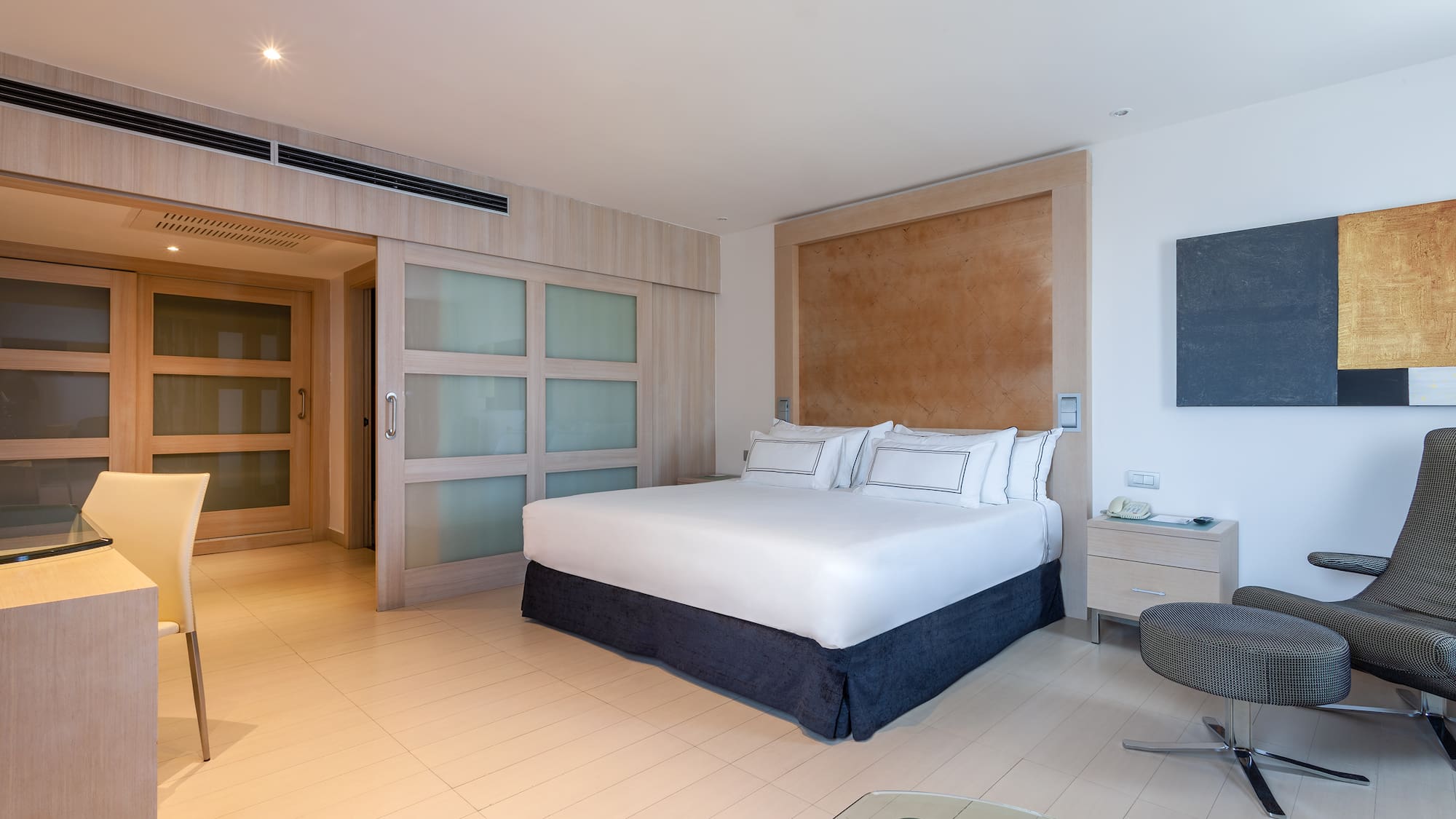 a bedroom with a bed and a glass table