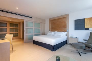 a bedroom with a bed and a glass table