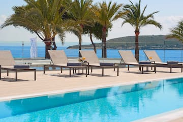 a pool with lounge chairs and palm trees