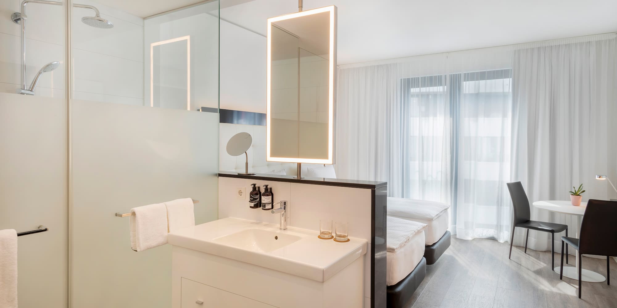 a bathroom with a mirror and a bed