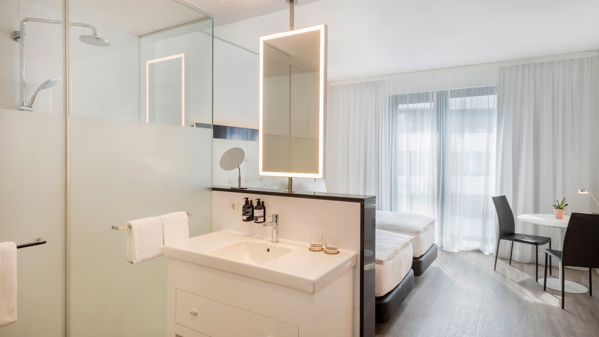 a bathroom with a mirror and a bed