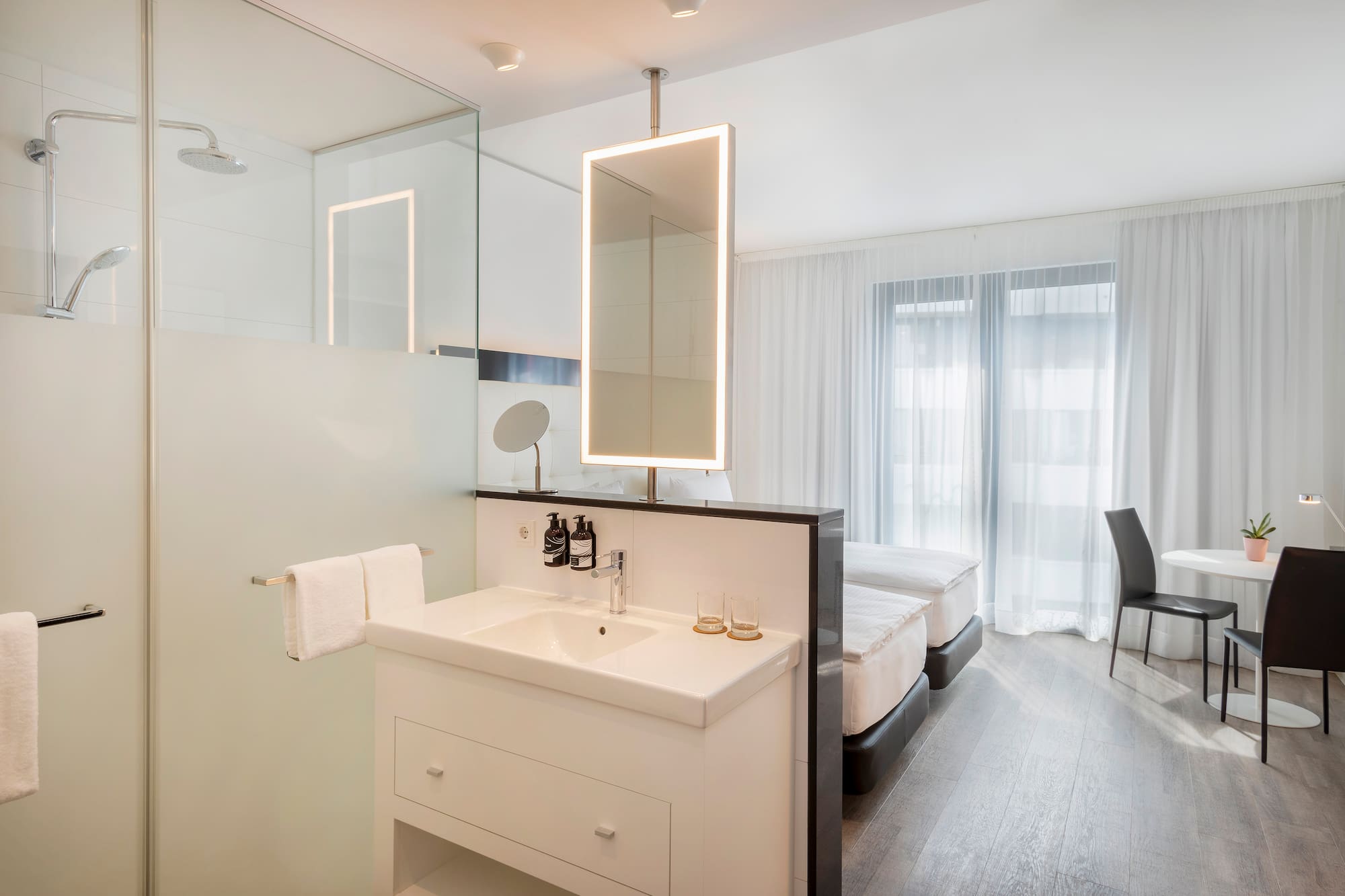 a bathroom with a mirror and a bed