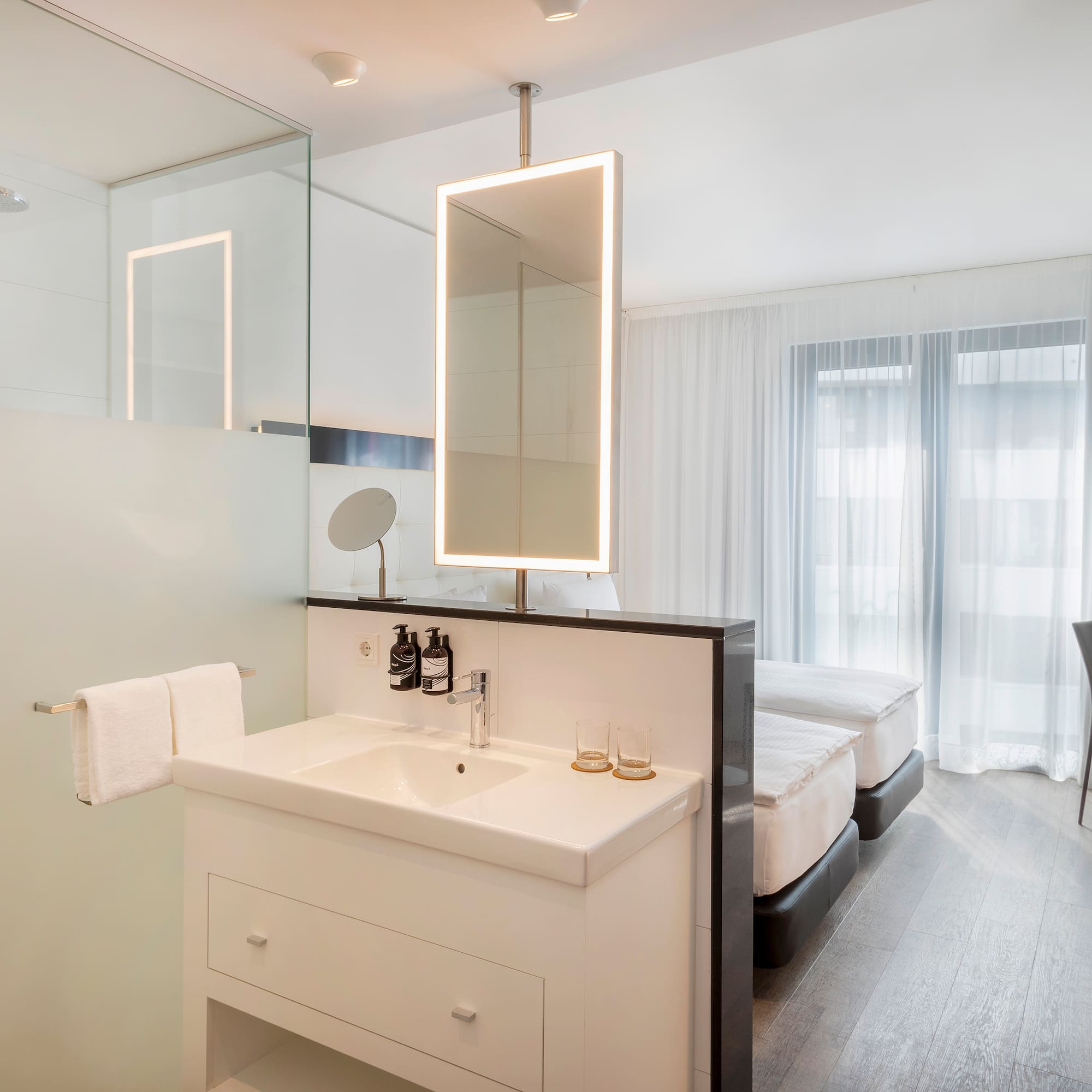 a bathroom with a mirror and a bed