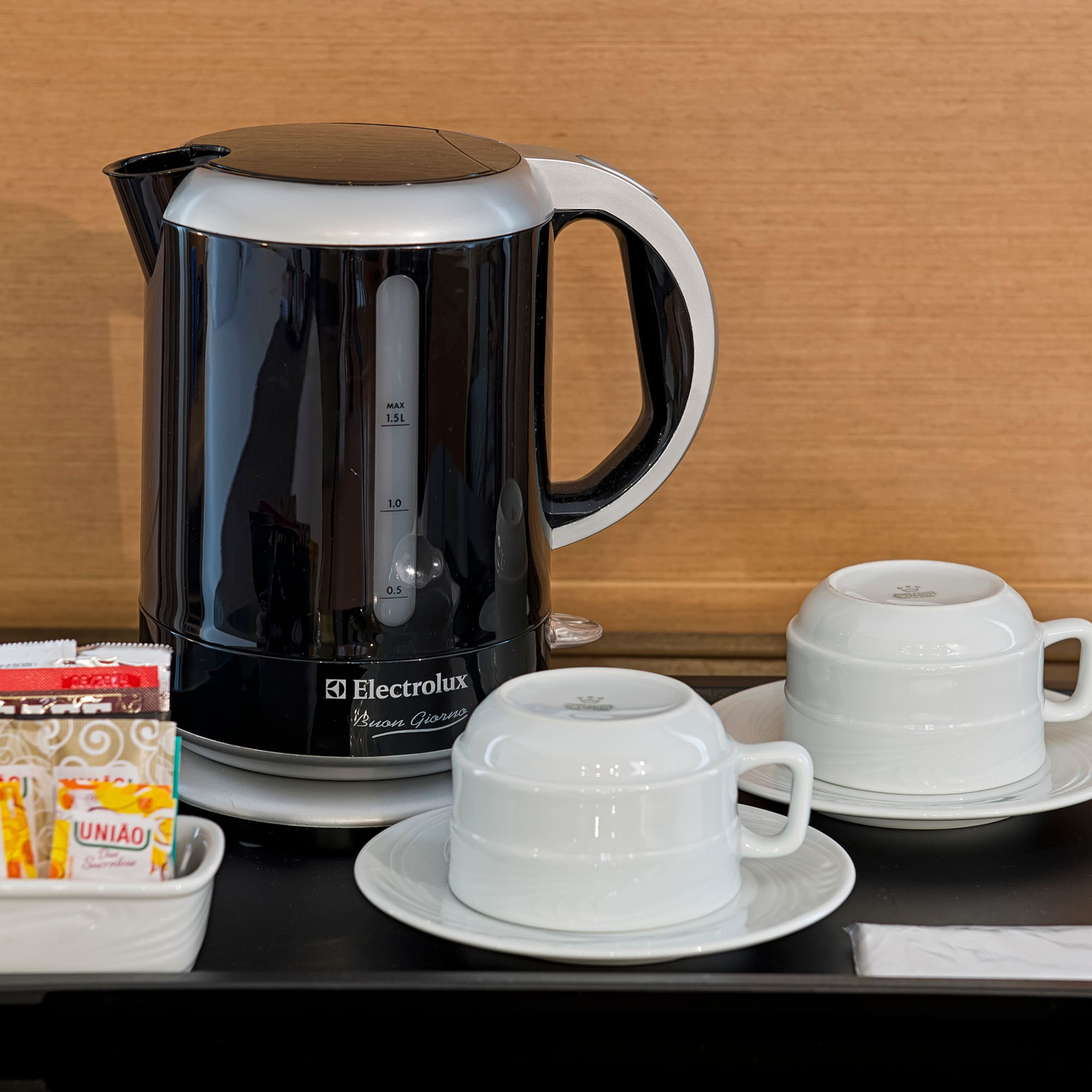a coffee pot and cups on a table