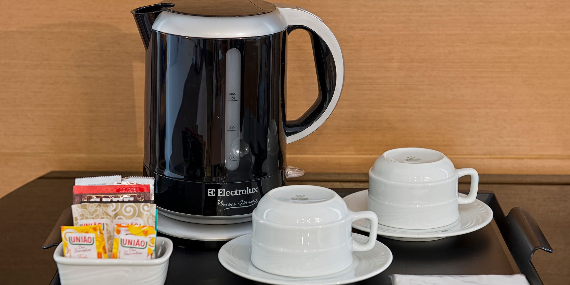 a coffee pot and cups on a table