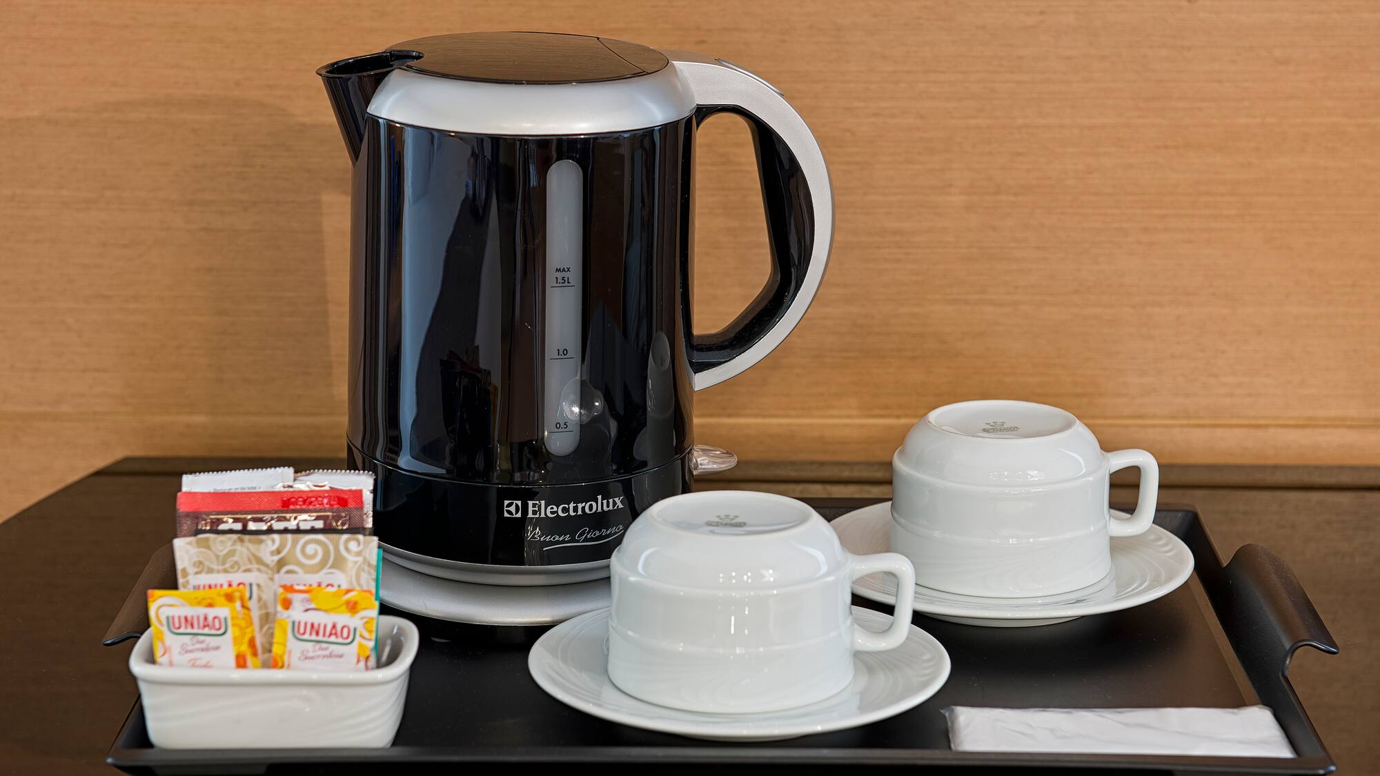 a coffee pot and cups on a table
