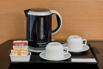 a coffee pot and cups on a table