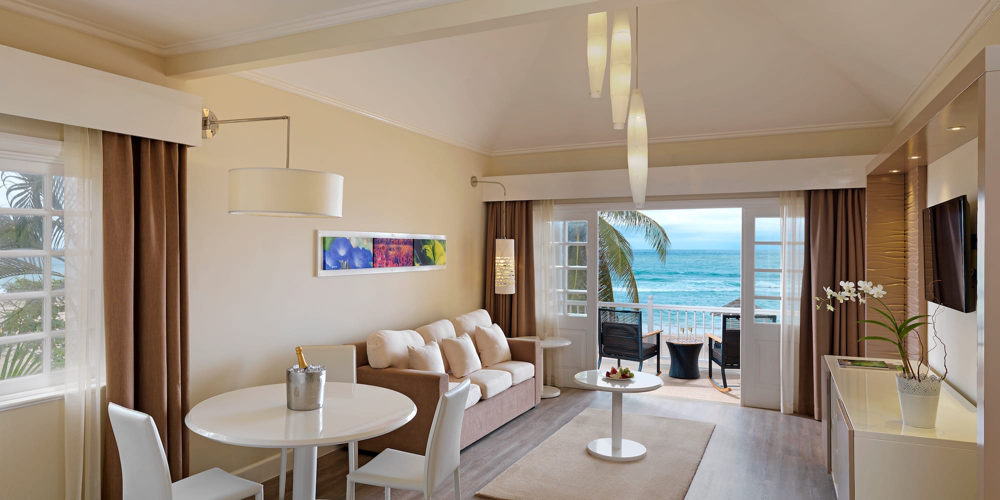 a room with a couch and a table and chairs