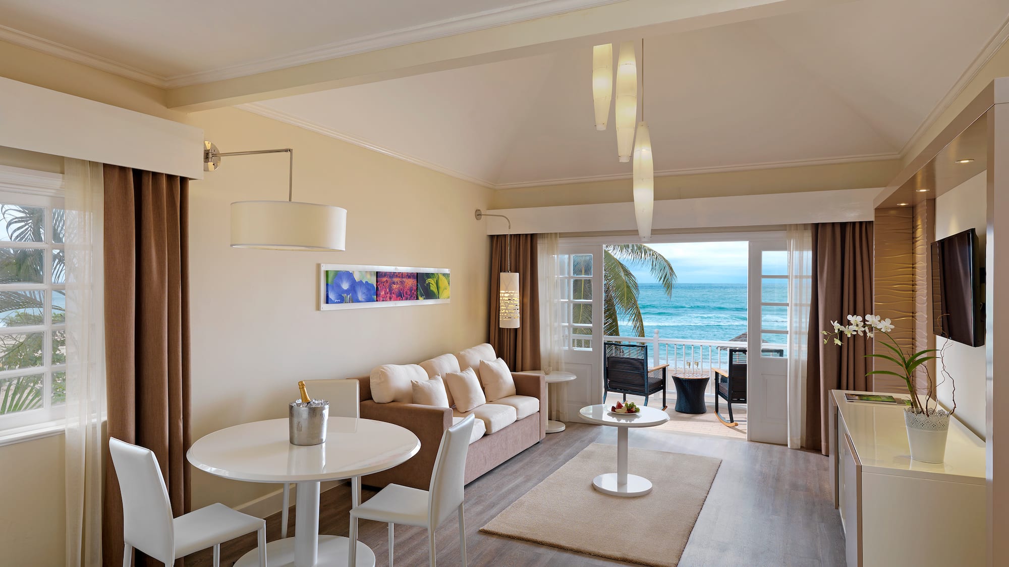 a room with a couch and a table and chairs