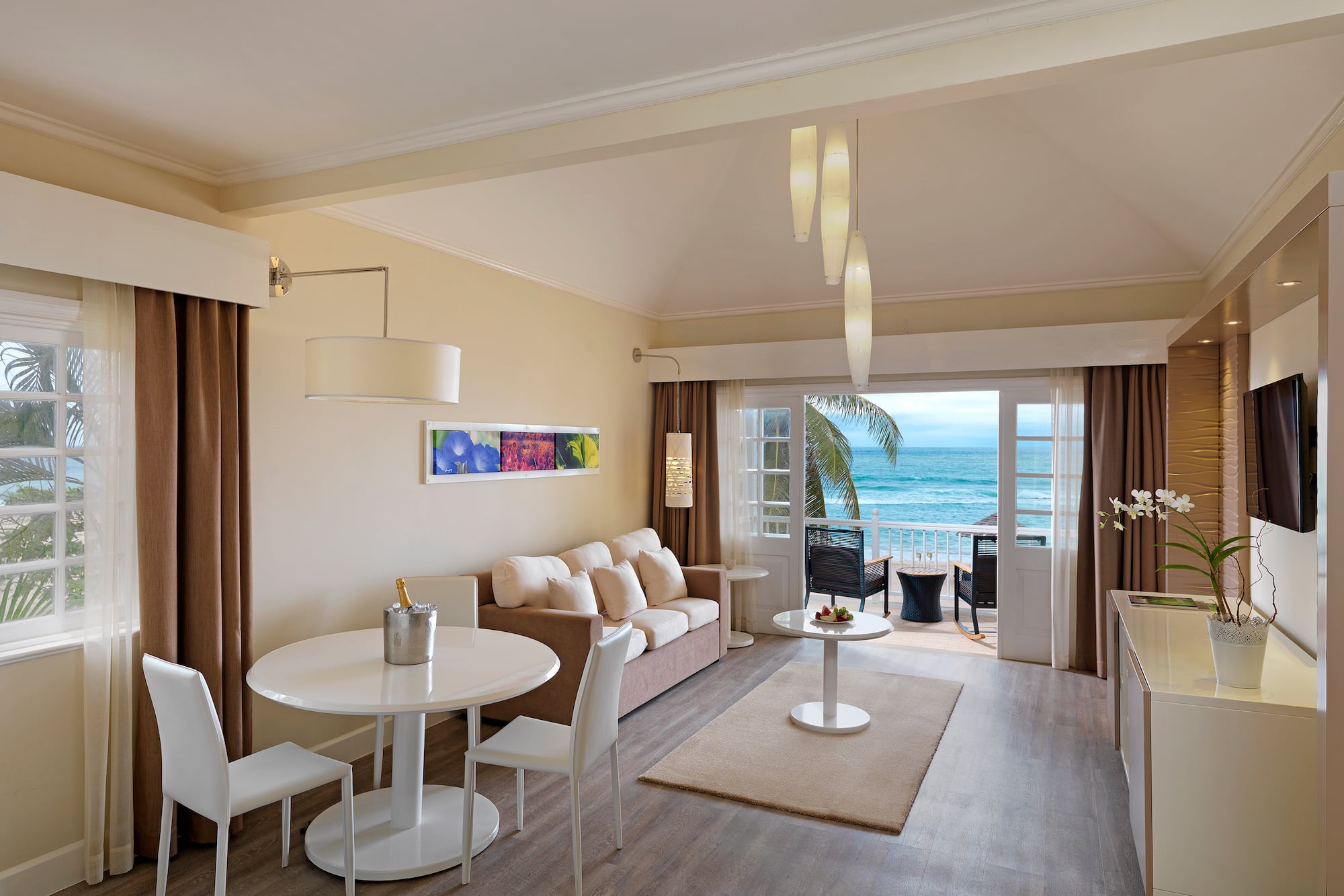 a room with a couch and a table and chairs