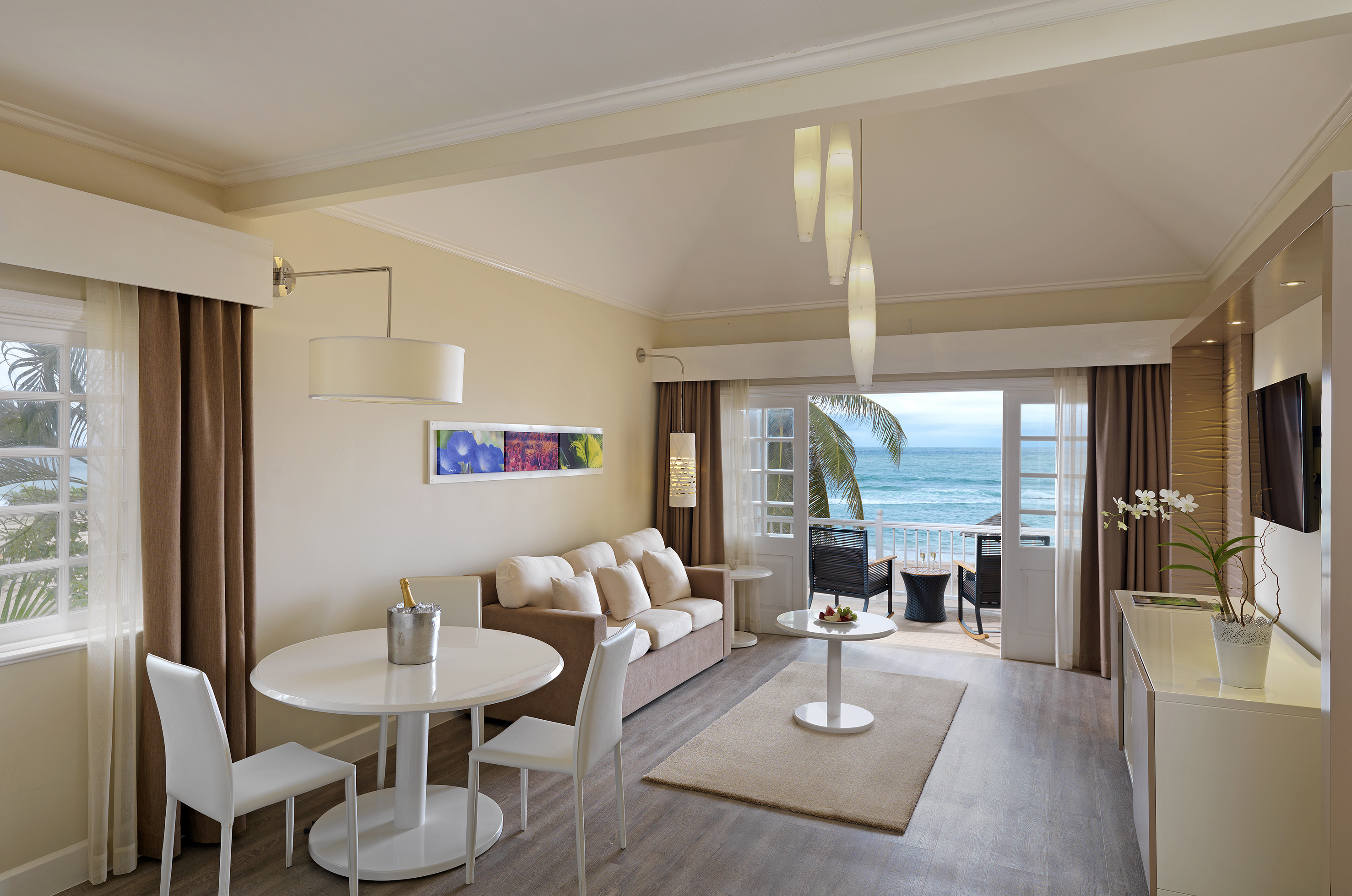 a room with a couch and a table and chairs