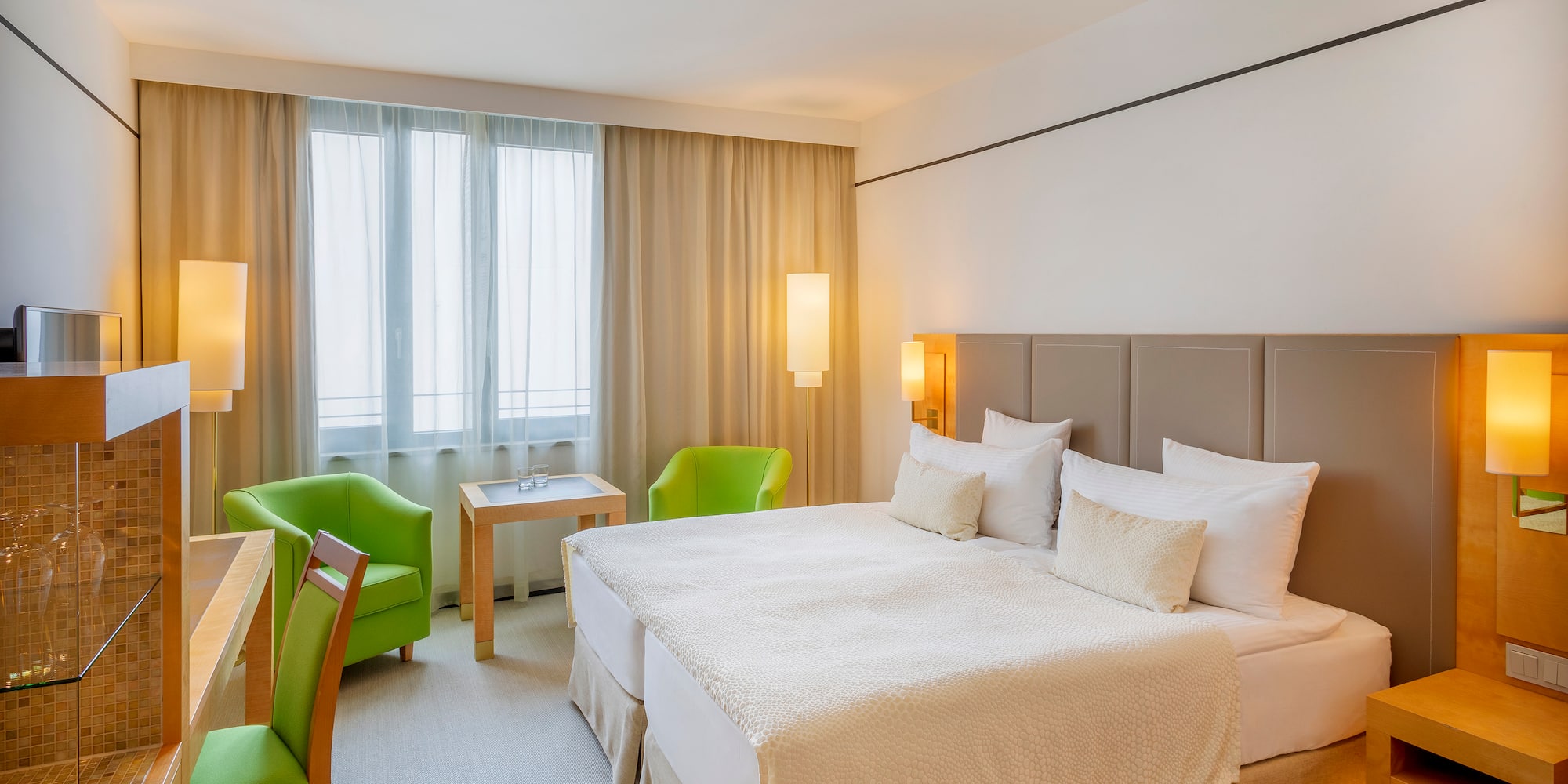 a room with a bed and chairs