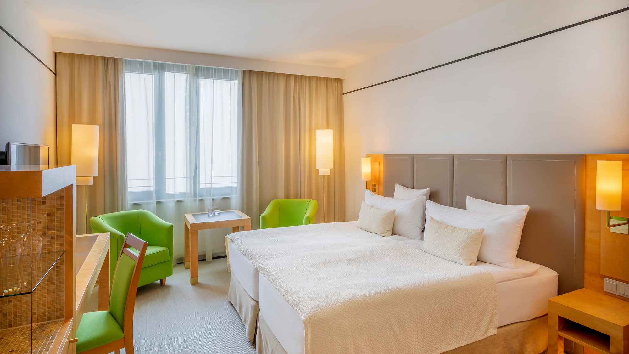 a room with a bed and chairs