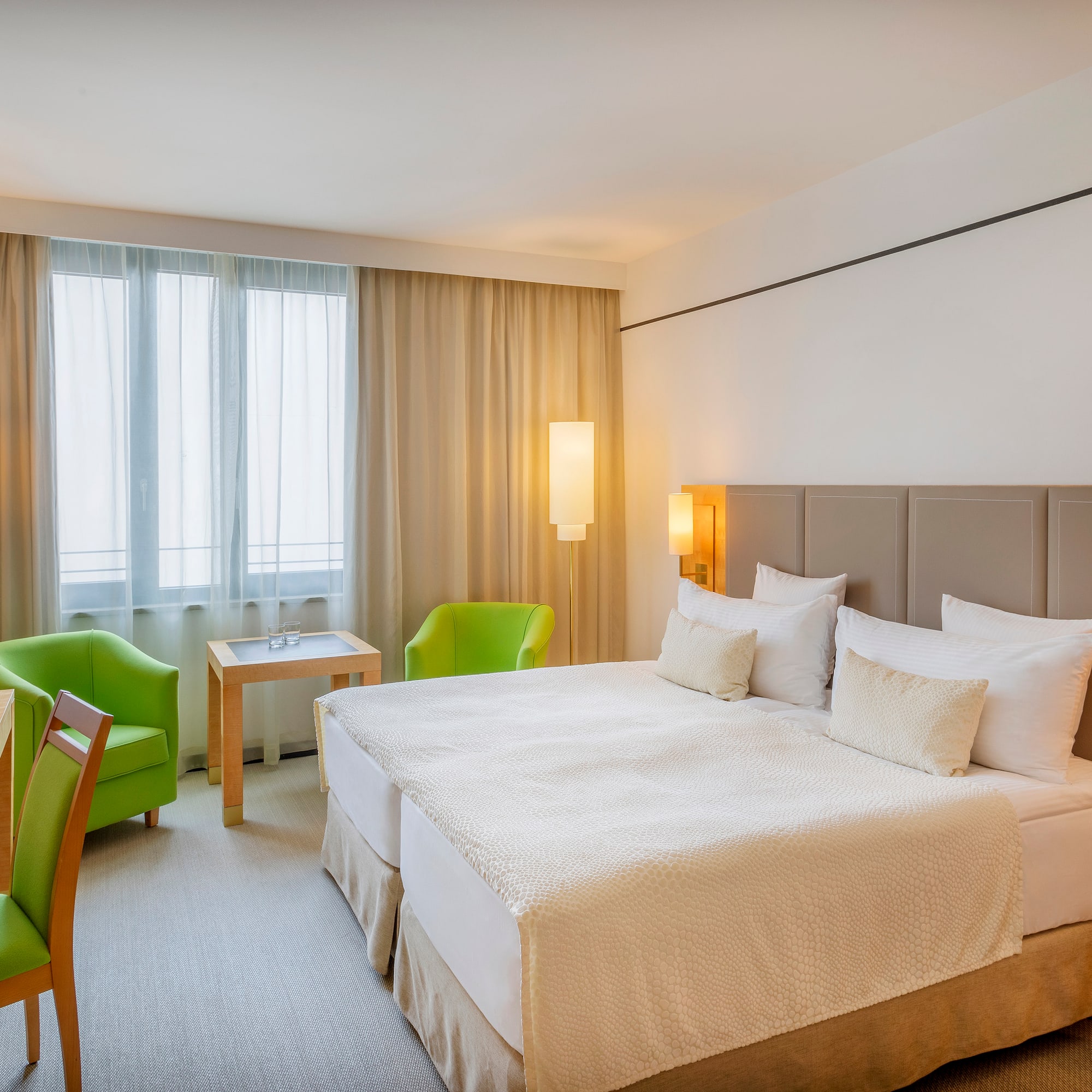 a room with a bed and chairs