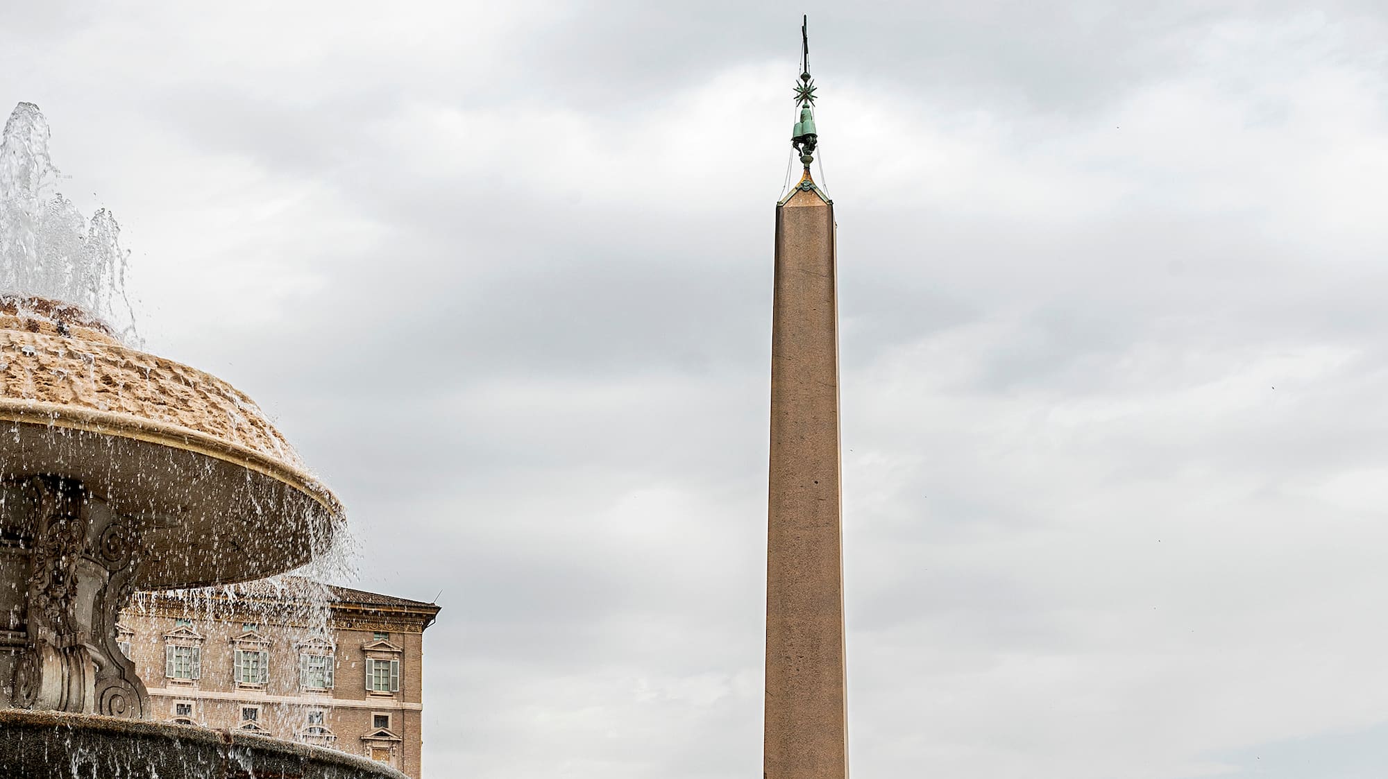 a fountain with a large obelisk in the background