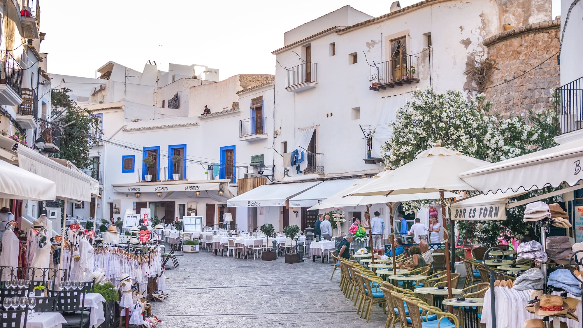 a street with tables and chairs and umbrellas