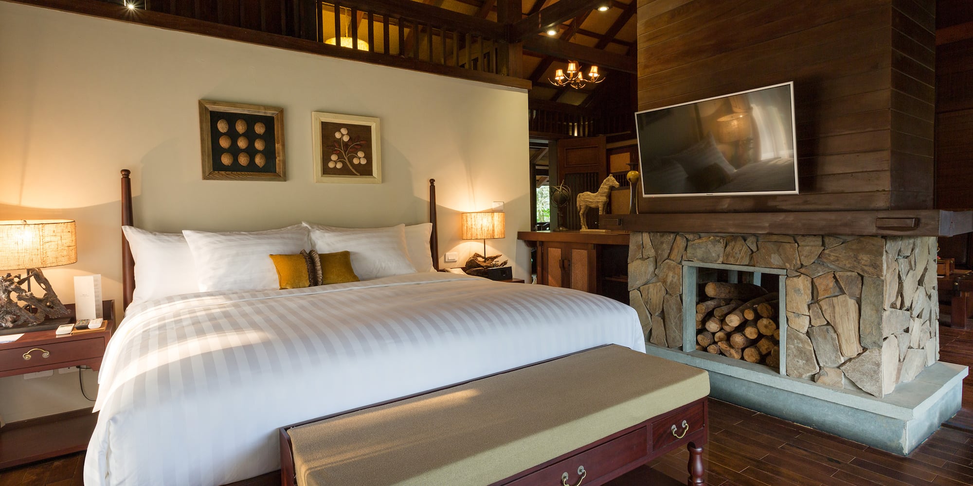 a bedroom with a fireplace and a bed