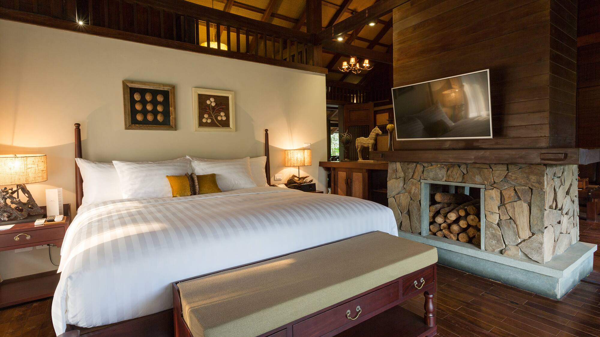 a bedroom with a fireplace and a bed