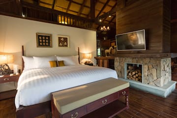 a bedroom with a fireplace and a bed