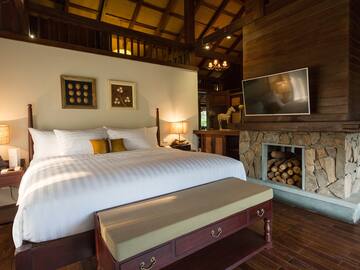 a bedroom with a fireplace and a bed