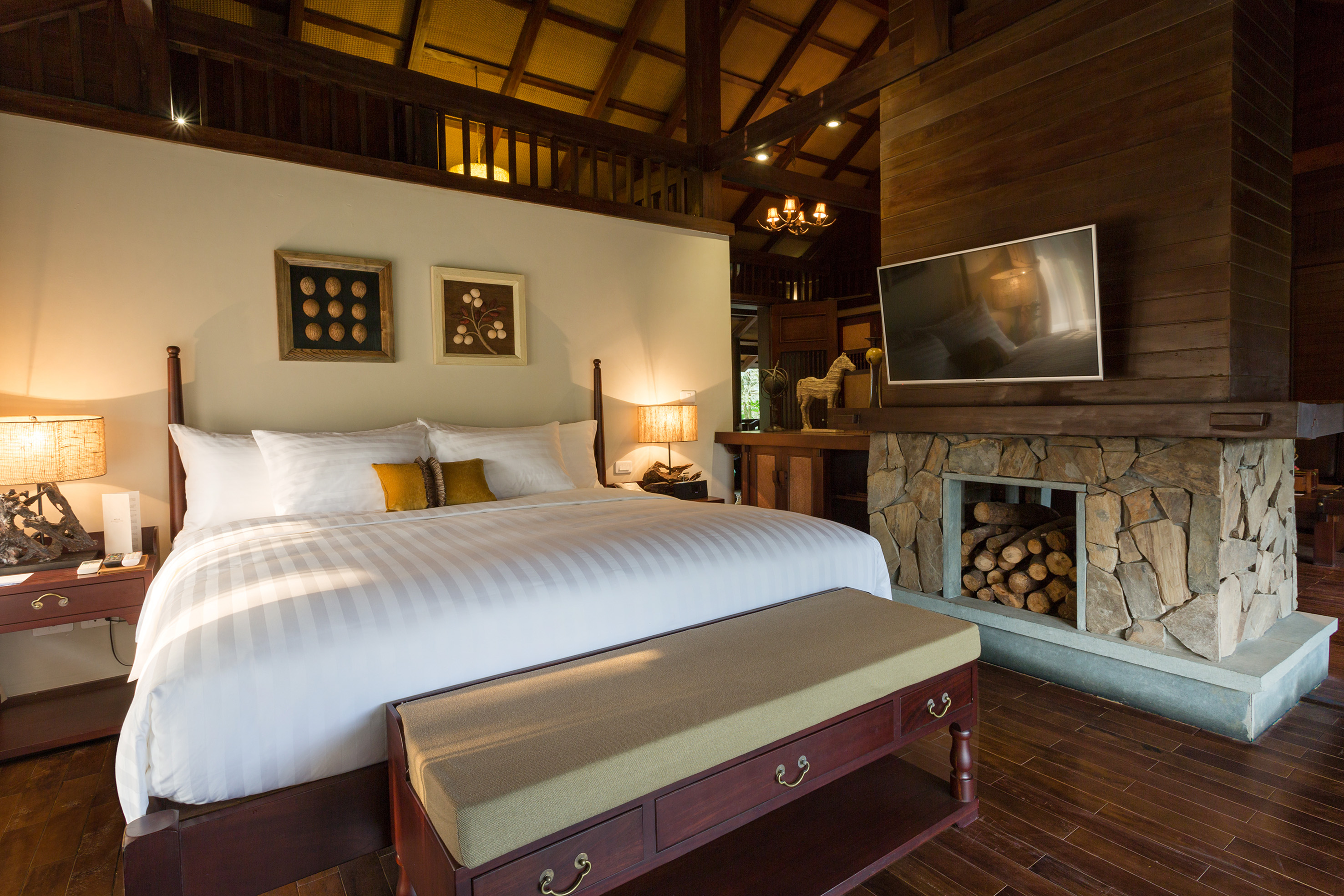 a bedroom with a fireplace and a bed