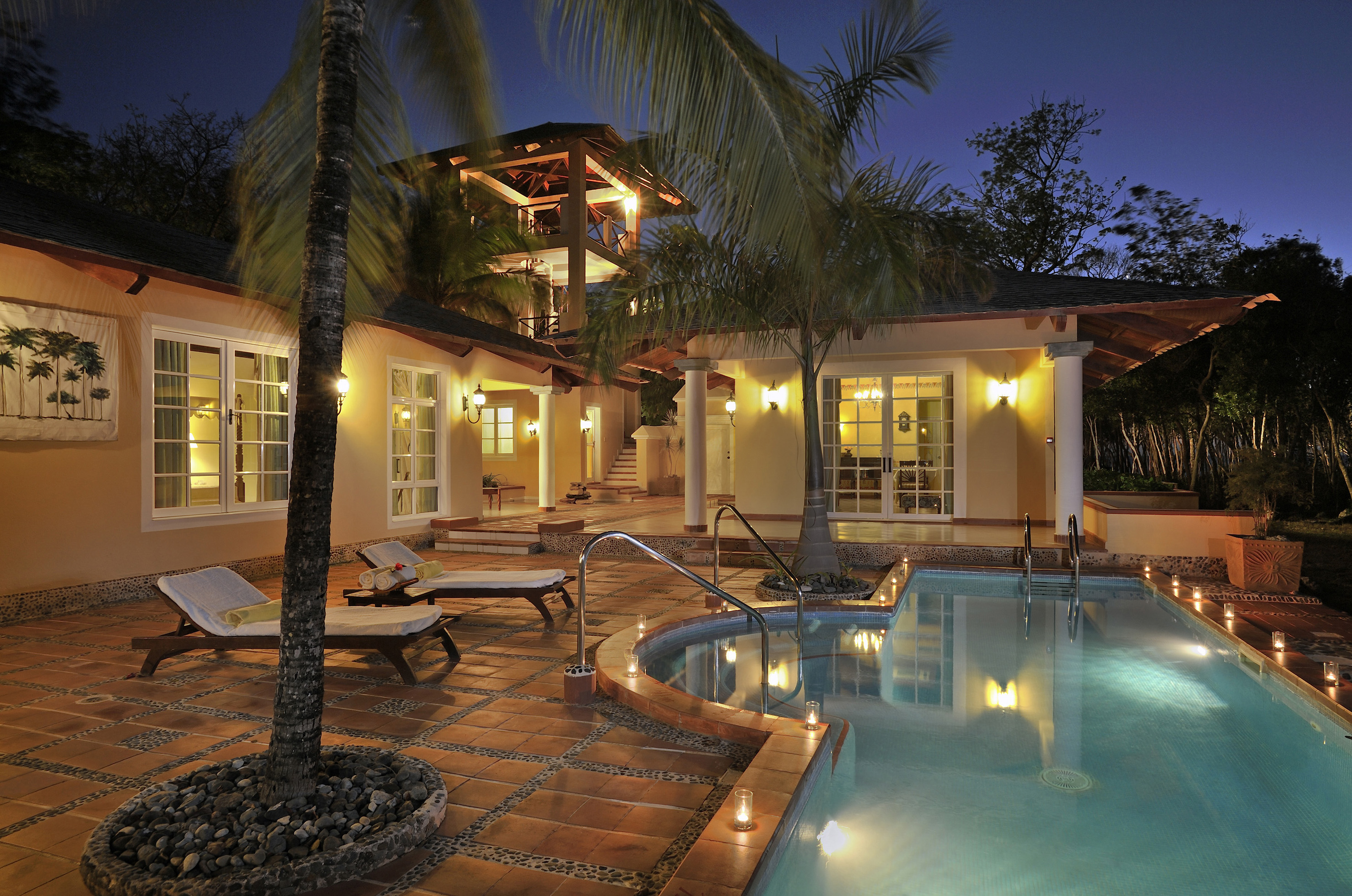 a pool and a house with palm trees