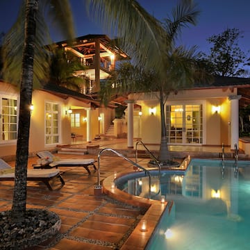a pool and a house with palm trees