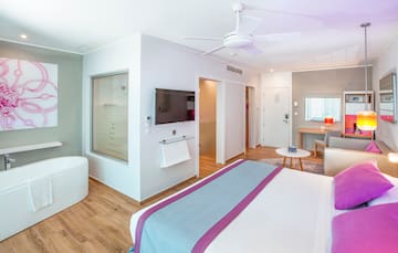 a bedroom with a bed and a television