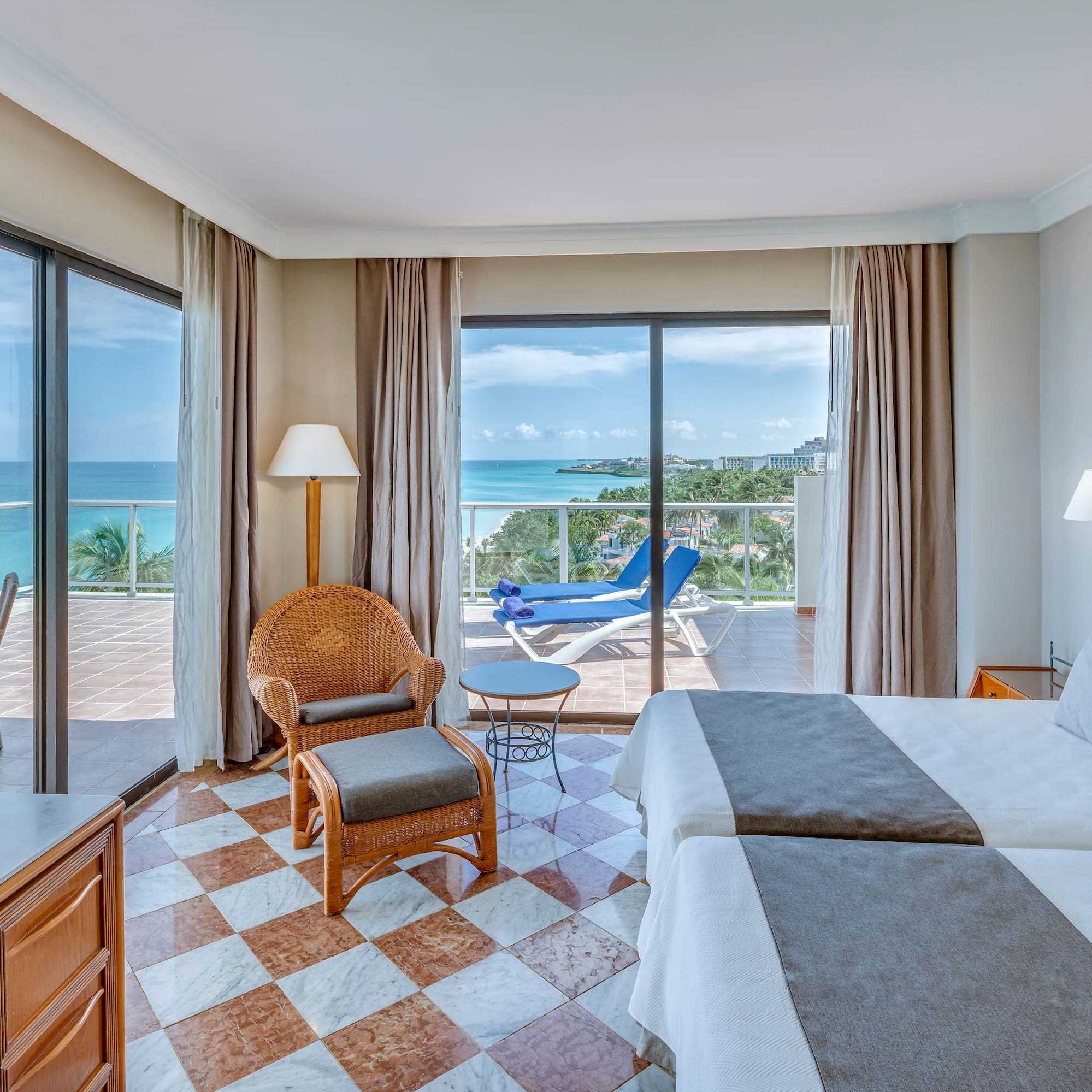 a room with a view of the ocean and a deck