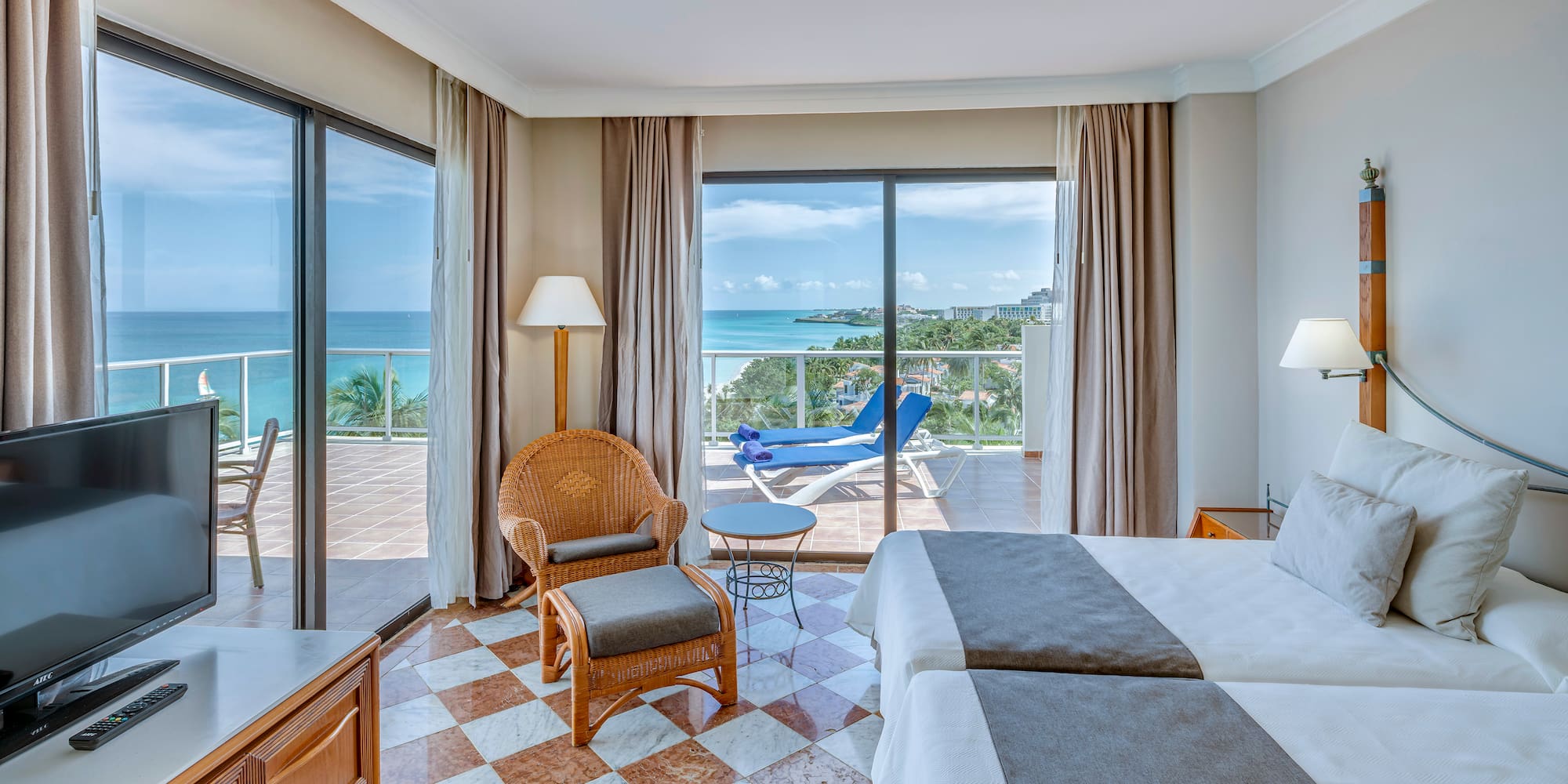 a room with a view of the ocean and a deck