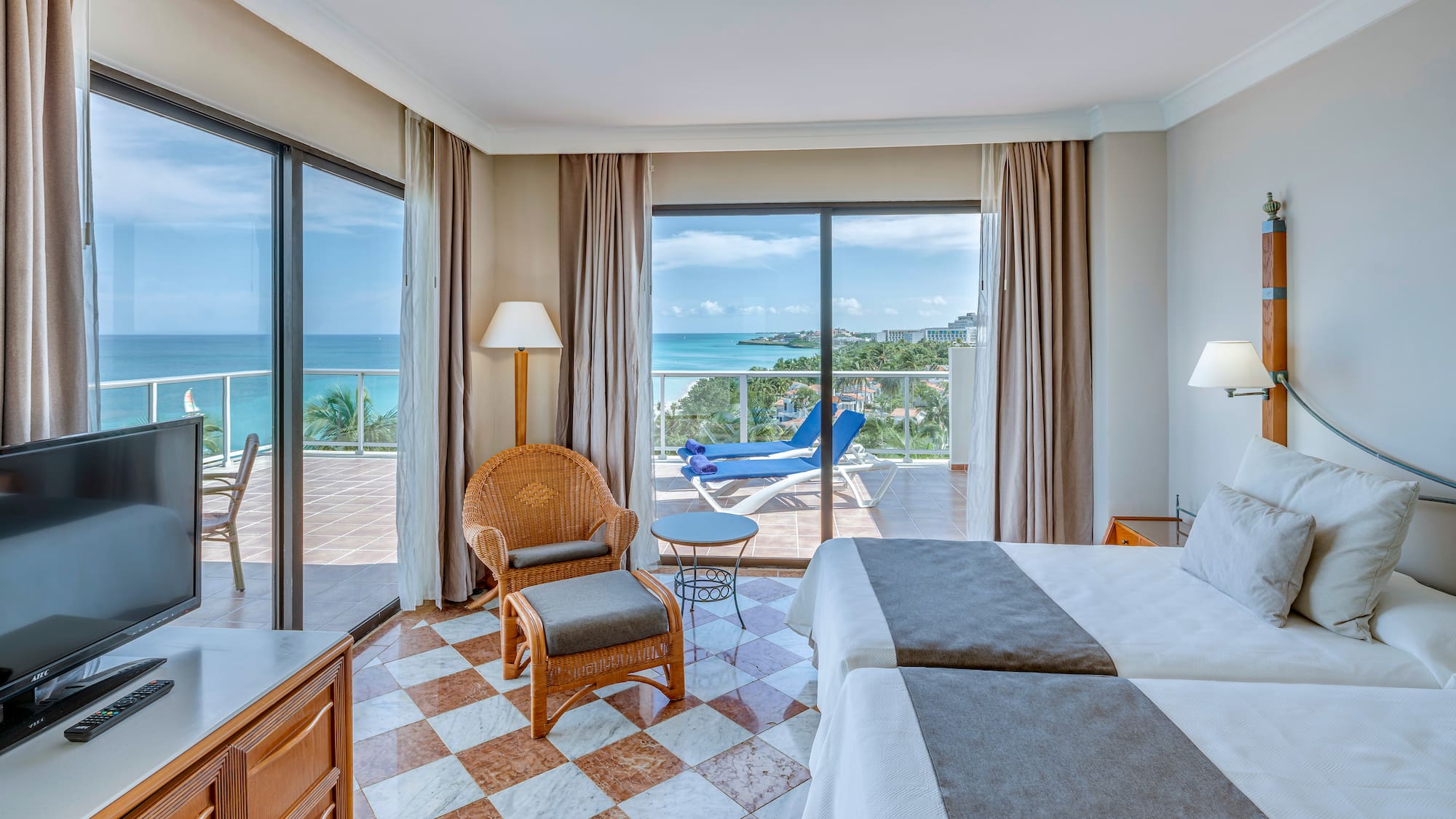 a room with a view of the ocean and a deck