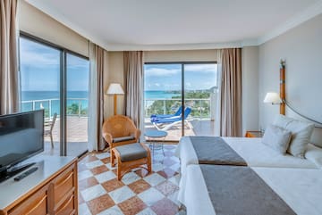 a room with a view of the ocean and a deck