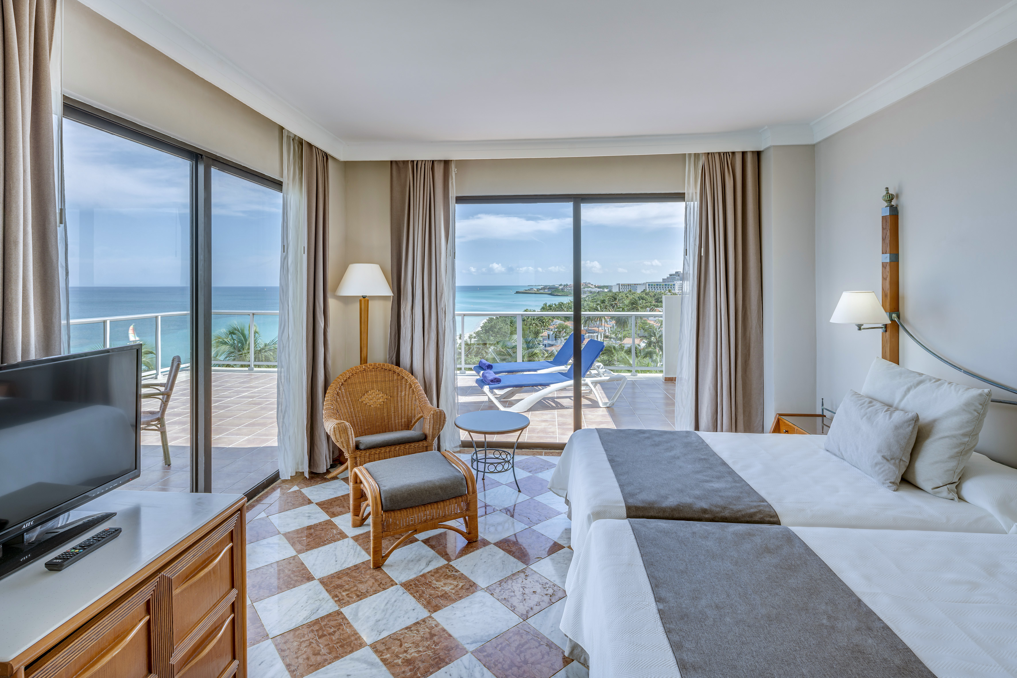 a room with a view of the ocean and a deck