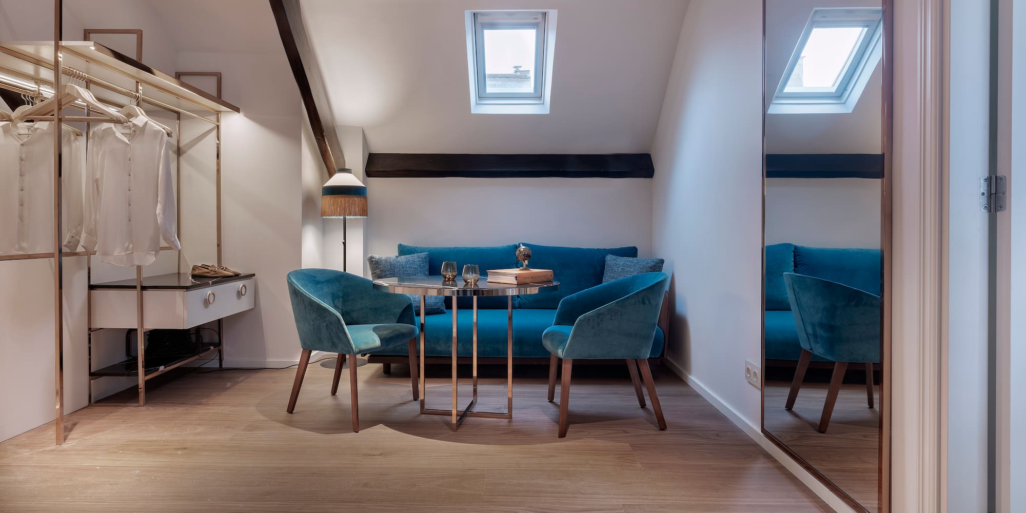 a room with a mirror and blue chairs